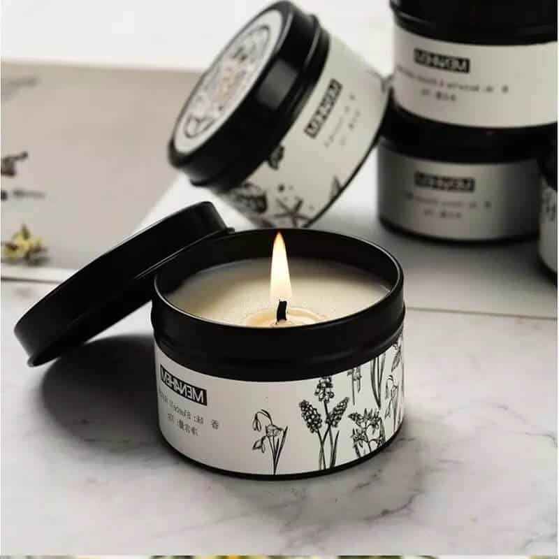 black burning scented candle in tin
