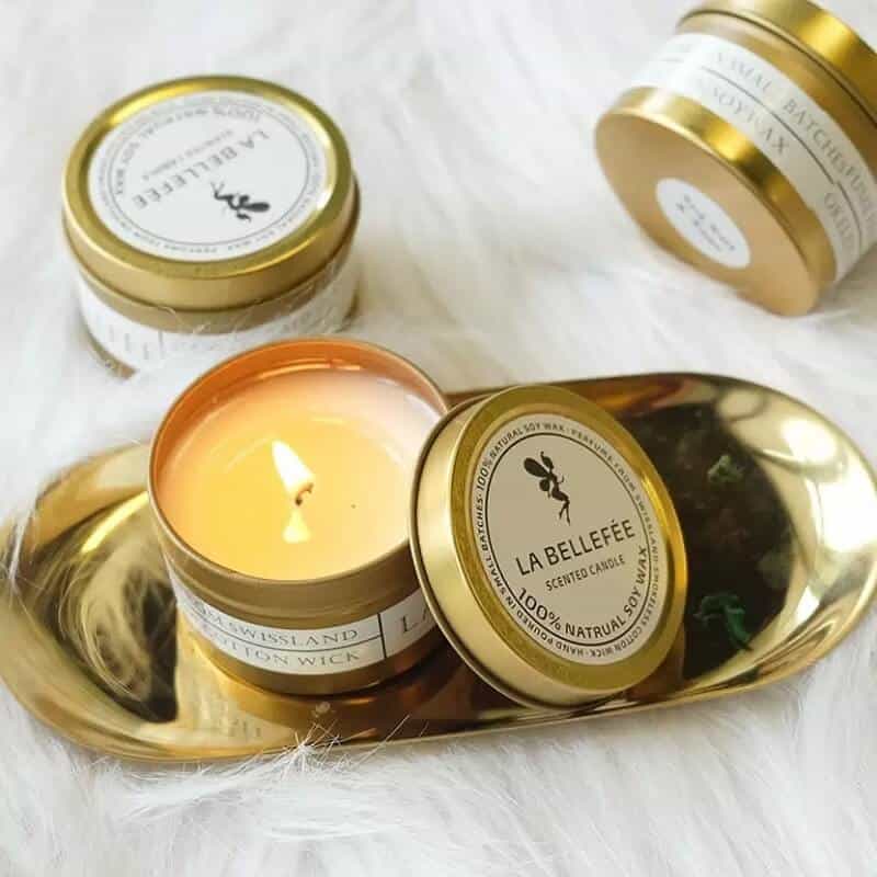 labeled gold scented candle tins